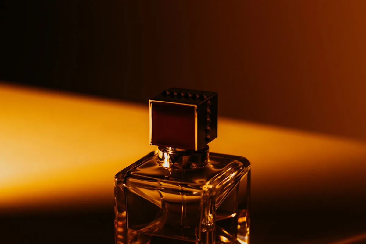 Valentino cologne bottle in dramatic low light — evening date-night mood