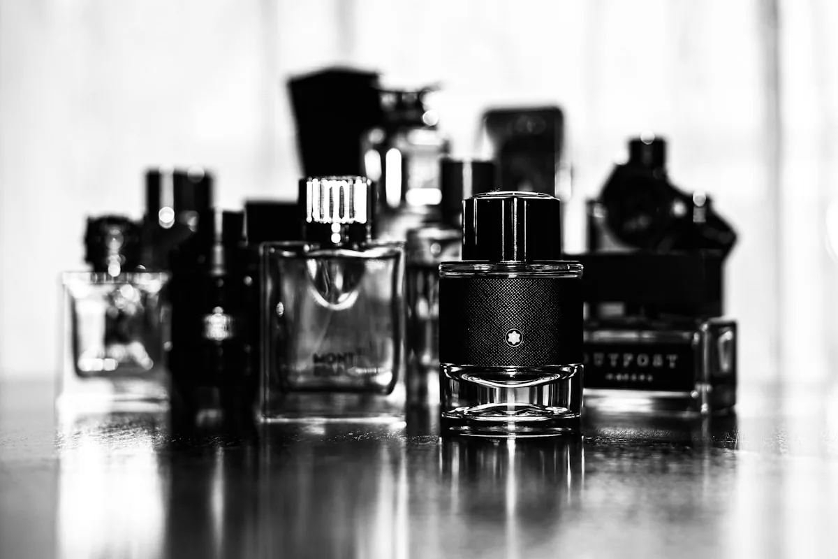 Grayscale lineup of perfume bottles on a neutral surface — gender-neutral picks